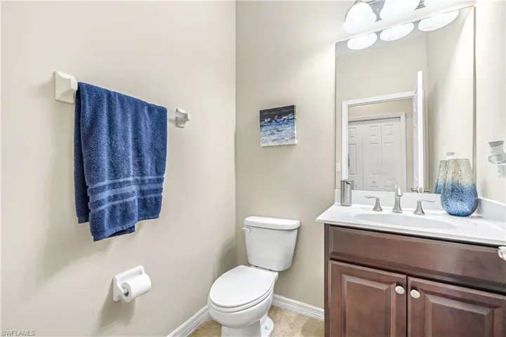 Half bathroom featuring vanity and toilet