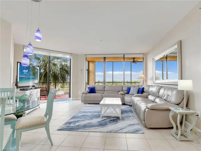 Tiled living room featuring floor to ceiling windows