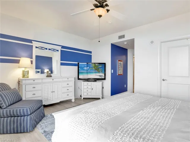 Bedroom featuring ceiling fan and wood-type flooring