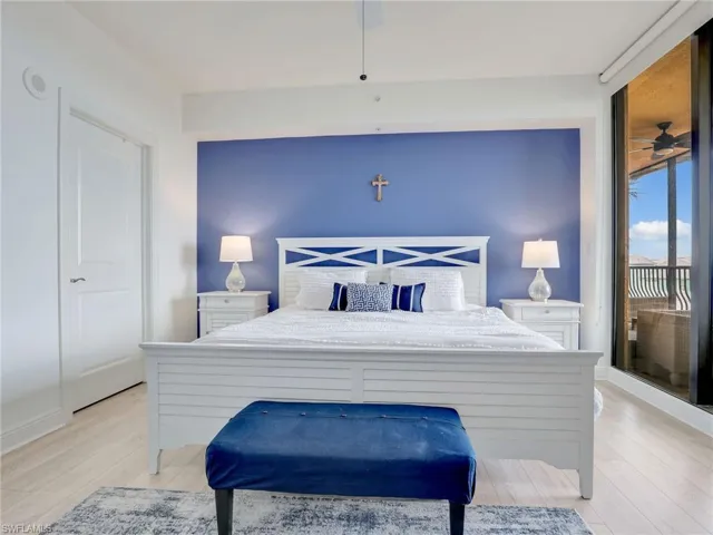 Bedroom featuring ceiling fan, light hardwood / wood-style flooring, and access to outside