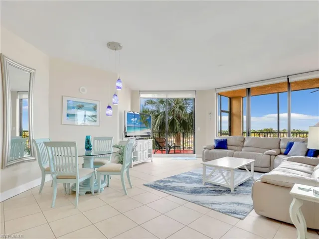 Tiled living room featuring plenty of natural light