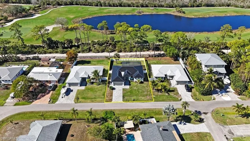 Property with a dark roof and a screened-in pool