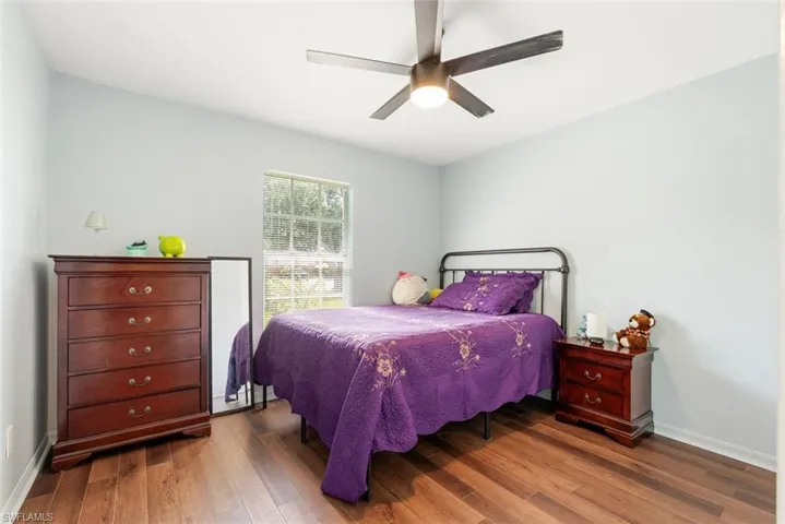 Bedroom with ceiling fan and hardwood / wood-style floors