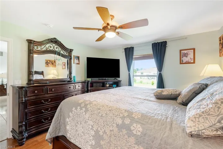Bedroom featuring wood-type flooring and ceiling fan