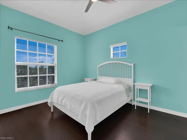 Bedroom featuring a ceiling fan and dark wood finished floors