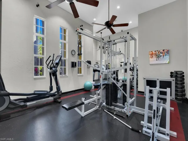Workout area with a ceiling fan and recessed lighting