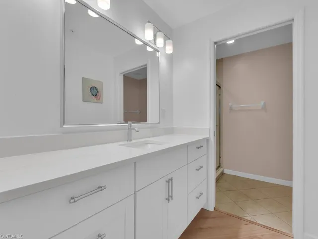 Bathroom with vanity, a shower stall, and light tile patterned flooring