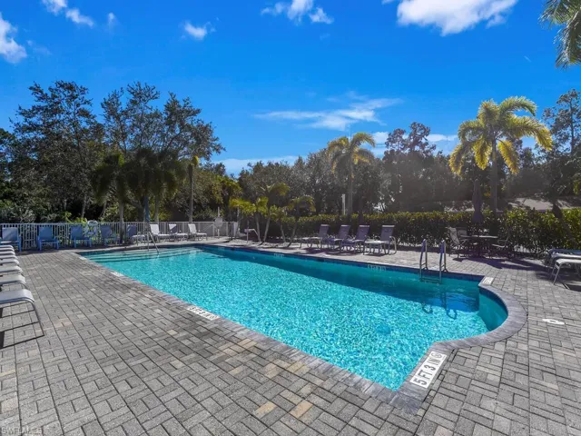 Community pool featuring a patio