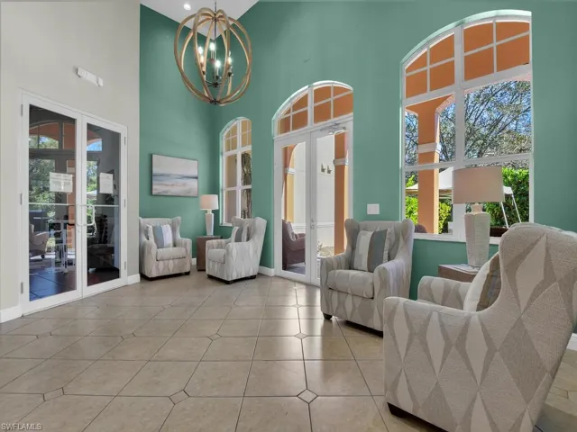 Sitting room with french doors, a high ceiling, and hanging lights