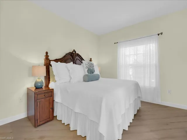 Bedroom with baseboards and light wood finished floors