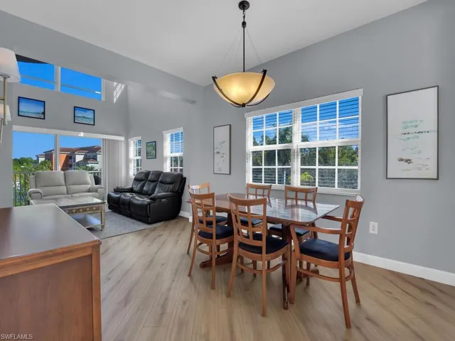 Dining room with light wood finished floors and a high ceiling