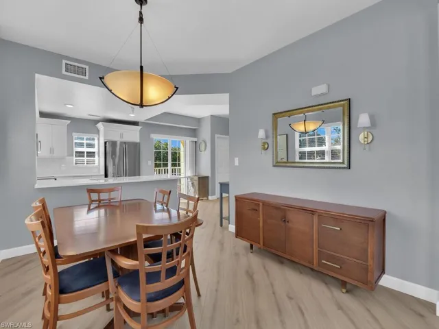 Dining area with baseboards and light wood-style flooring