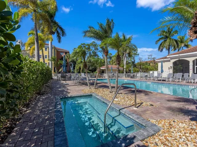 Community pool featuring a patio area and a hot tub