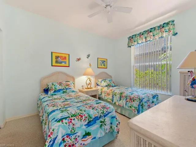 Bedroom featuring carpet, baseboards, and ceiling fan
