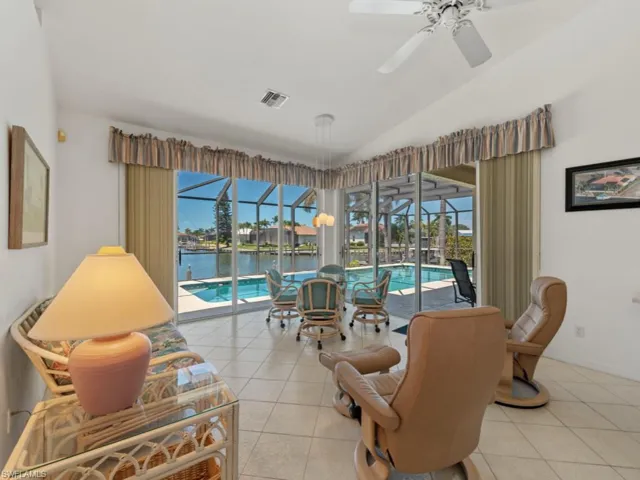 Living area with a sunroom, a healthy amount of sunlight, a ceiling fan, and visible vents