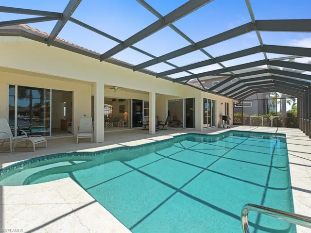 Outdoor pool with ceiling fan, a patio, and a lanai