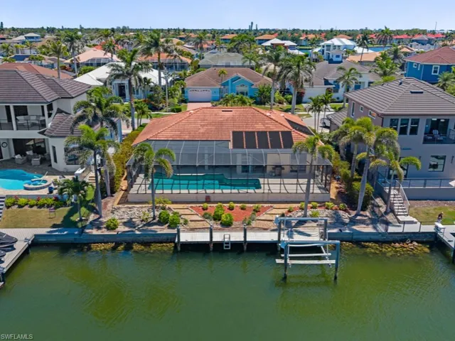 Birds eye view of property featuring a water view and a residential view