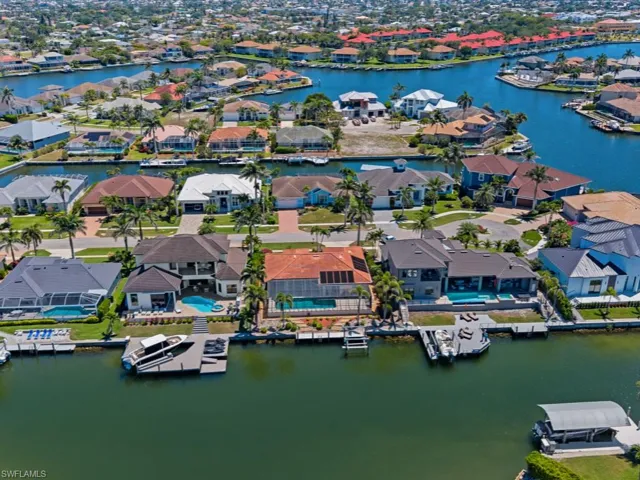 Drone / aerial view with a water view and a residential view