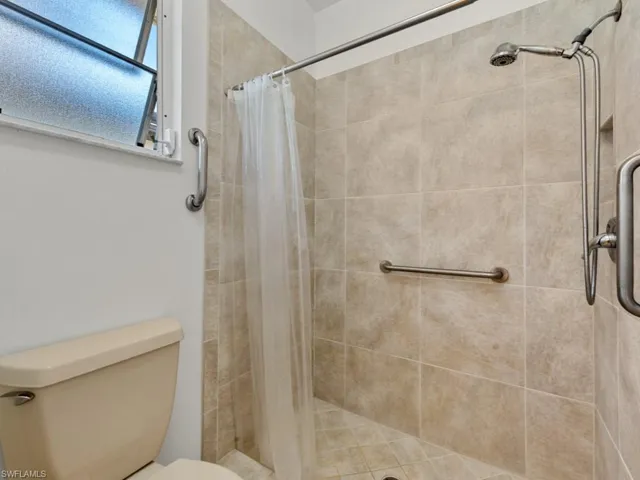Bathroom with toilet and a stall shower