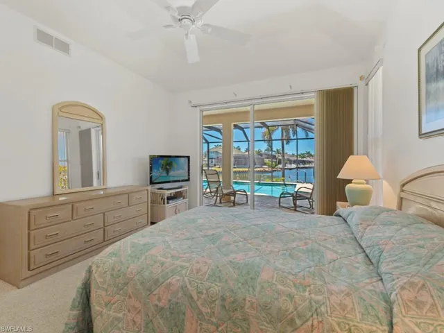 Bedroom featuring lofted ceiling, access to outside, carpet floors, visible vents, and ceiling fan