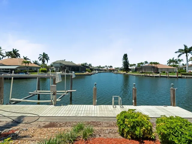 Dock area with a residential view and a water view