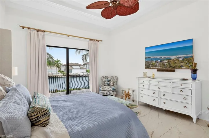 Bedroom featuring light marble finish flooring, access to outside, ceiling fan, and crown molding