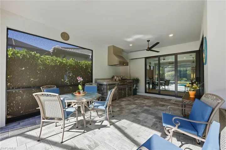 View of patio / terrace with an outdoor kitchen / dining area and ceiling fan