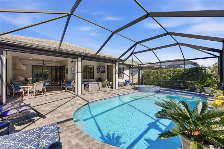 Integrated pool / spa featuring a sunroom, a lanai, outdoor dining area, and a patio area
