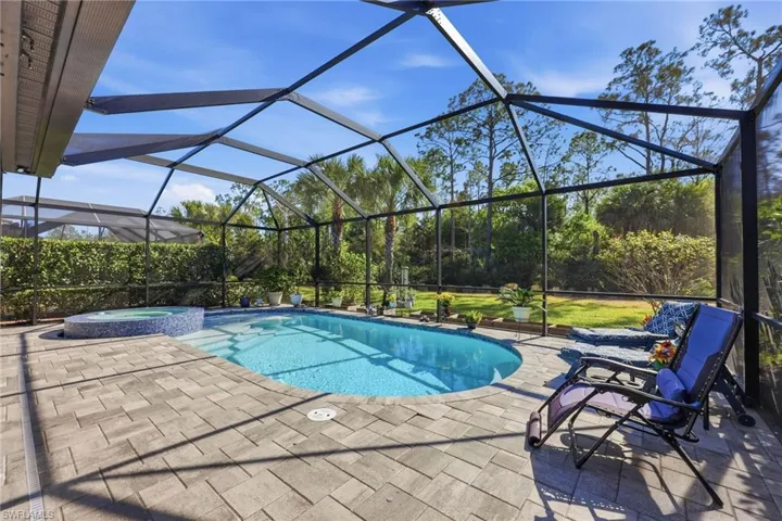 Relaxing pool / spa with a lanai, a sunroom, and a patio
