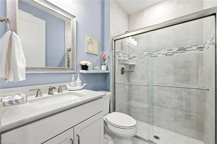Full bathroom with a shower stall and vanity