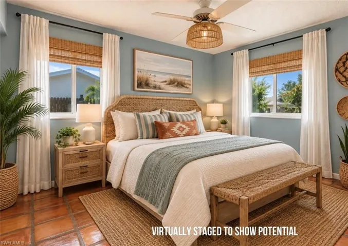 VIRTUALLY STAGED  Terracotta tile flooring, dual windows with bamboo shades and curtain rods, and a ceiling fan with integrated lighting