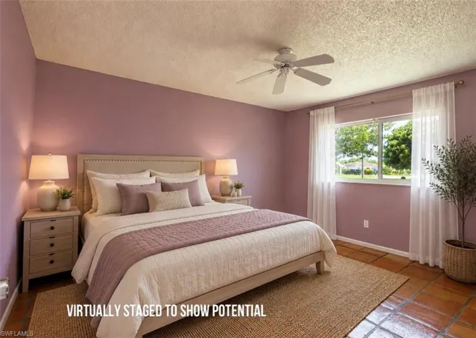 VIRTUALLY STAGED  Window with natural light, ceiling fan, and tiled flooring