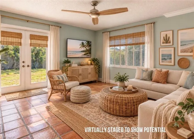 VIRTUALLY STAGED  Terracotta tile flooring, a ceiling fan with wood-finish blades, double French doors, and a window with horizontal blinds
