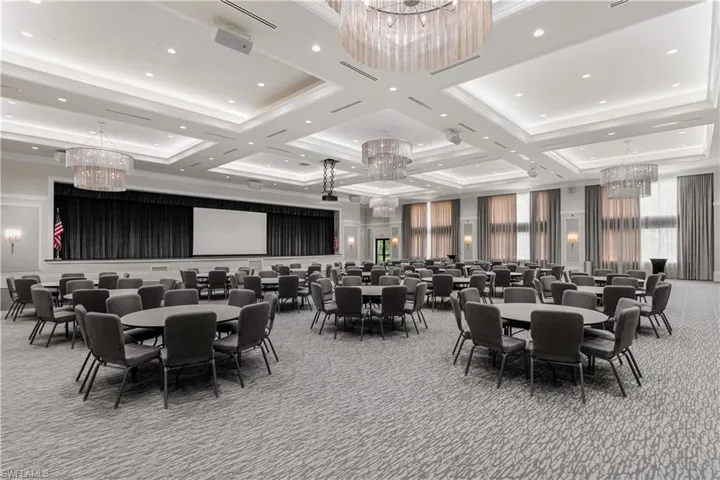 Dining space featuring light carpet, a chandelier, and coffered ceiling