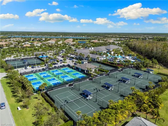 Aerial perspective of suburban area featuring a nearby body of water