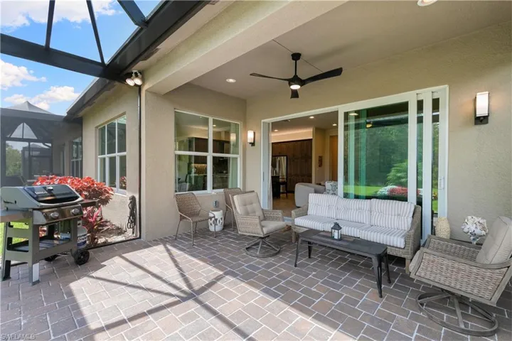 View of patio / terrace featuring area for grilling, a ceiling fan, and a lanai