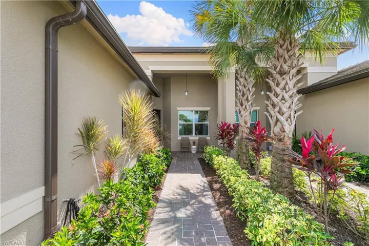 Doorway to property featuring stucco siding