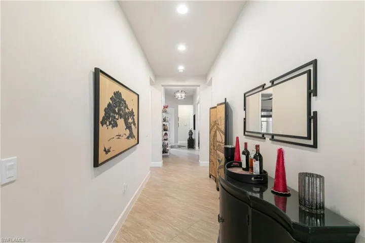 Hallway featuring recessed lighting and baseboards