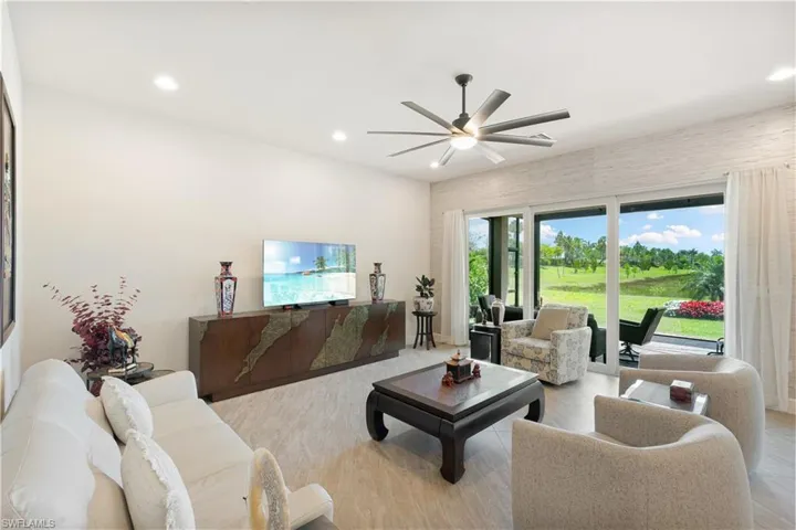 Living area featuring ceiling fan and recessed lighting