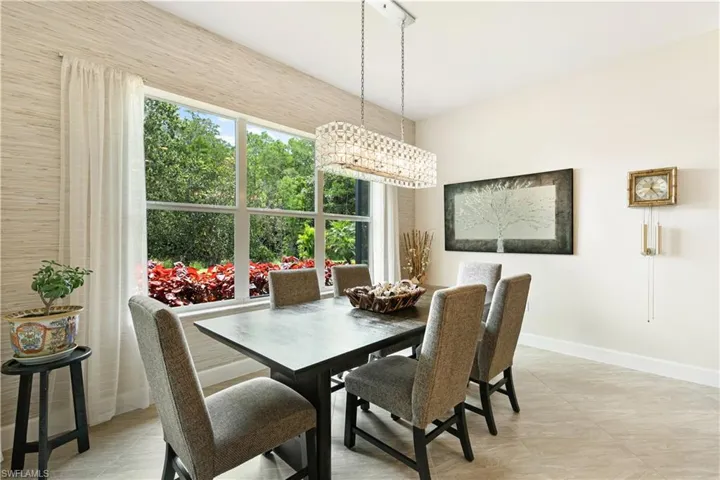 Dining area with baseboards and light tile patterned flooring