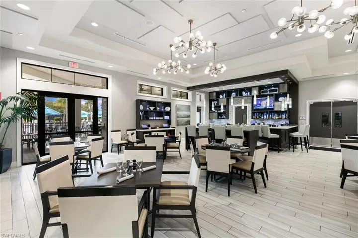 Dining space with a tray ceiling and a chandelier