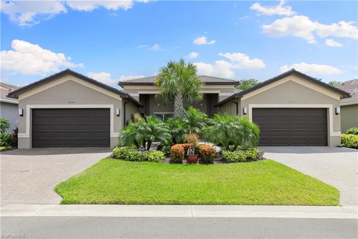 Single story home featuring stucco siding, decorative driveway, and a garage