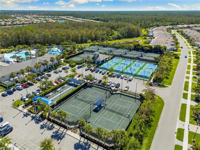 Drone / aerial view of a heavily wooded area and a pool