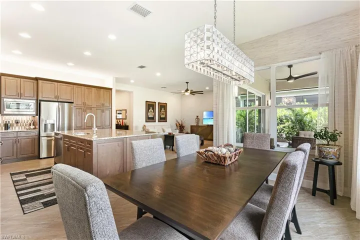 Dining space with ceiling fan and recessed lighting