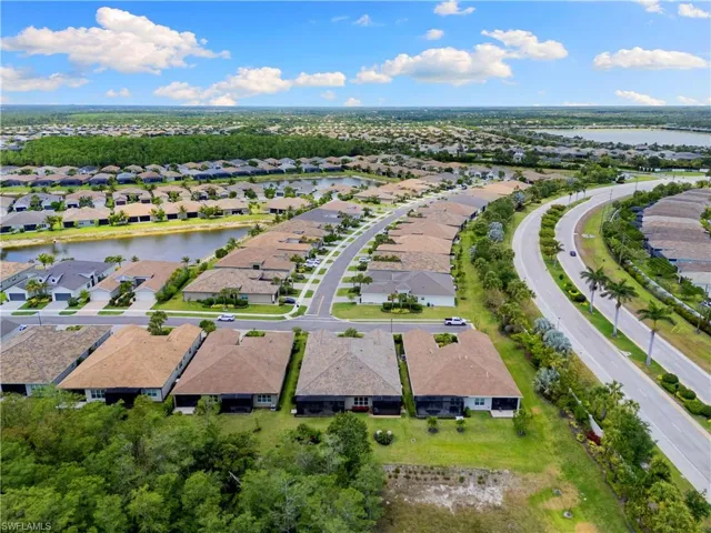 Aerial view of residential area featuring a nearby body of water
