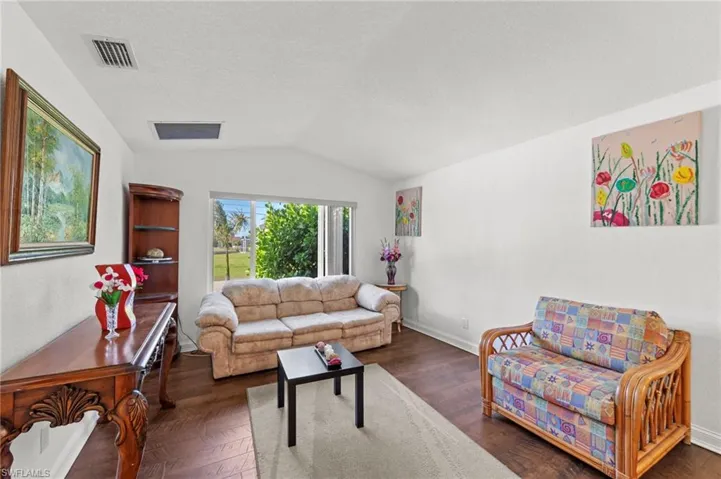 Living area featuring dark wood-style flooring