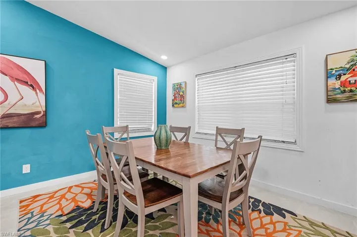 Dining area with vaulted ceiling and recessed lighting