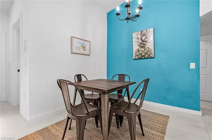 Dining room featuring a chandelier and baseboards