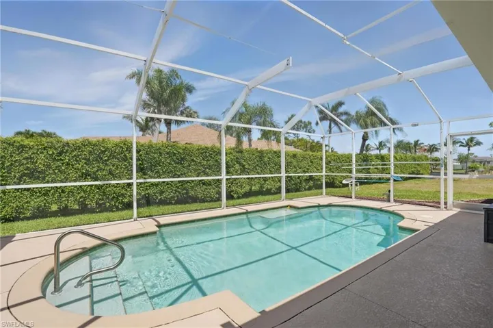 View of swimming pool featuring a lanai and a patio