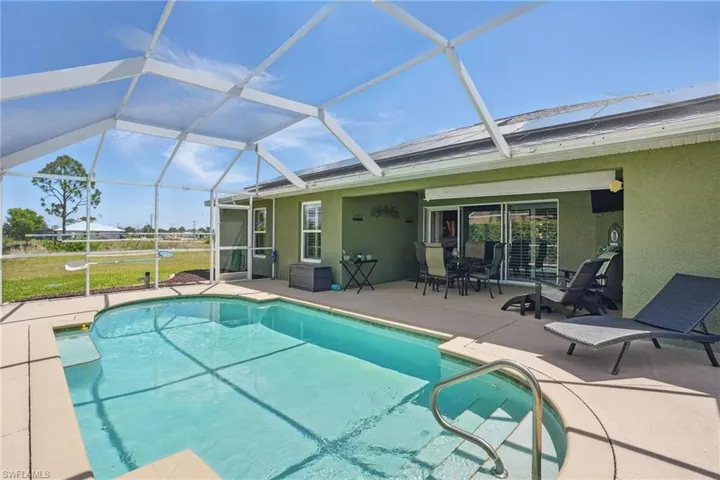 Swimming pool featuring a patio and a lanai